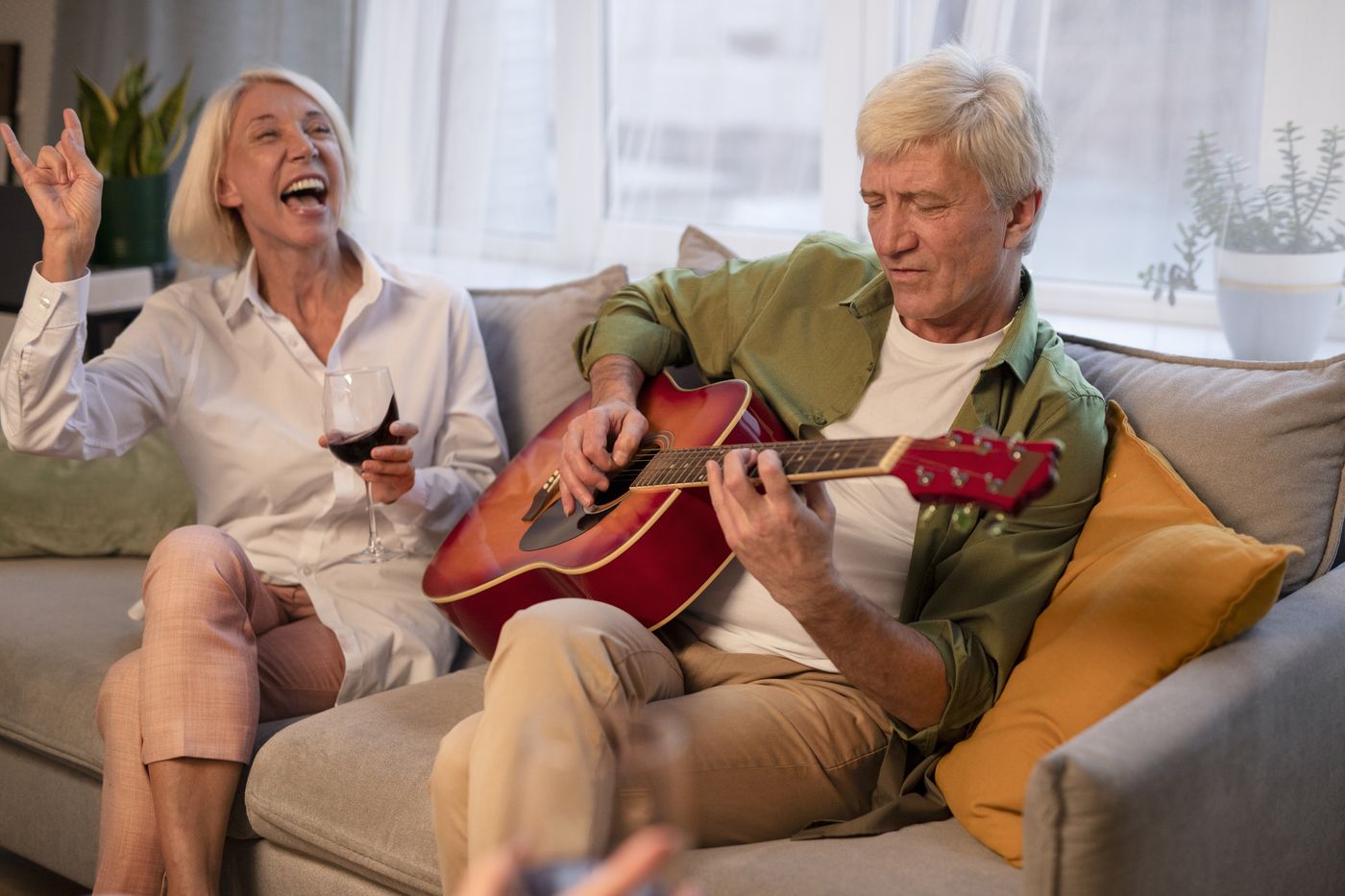A resident singing along while a companion plays the guitar