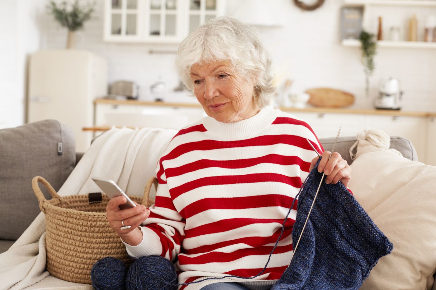 A resident knitting contentedly on the sofa