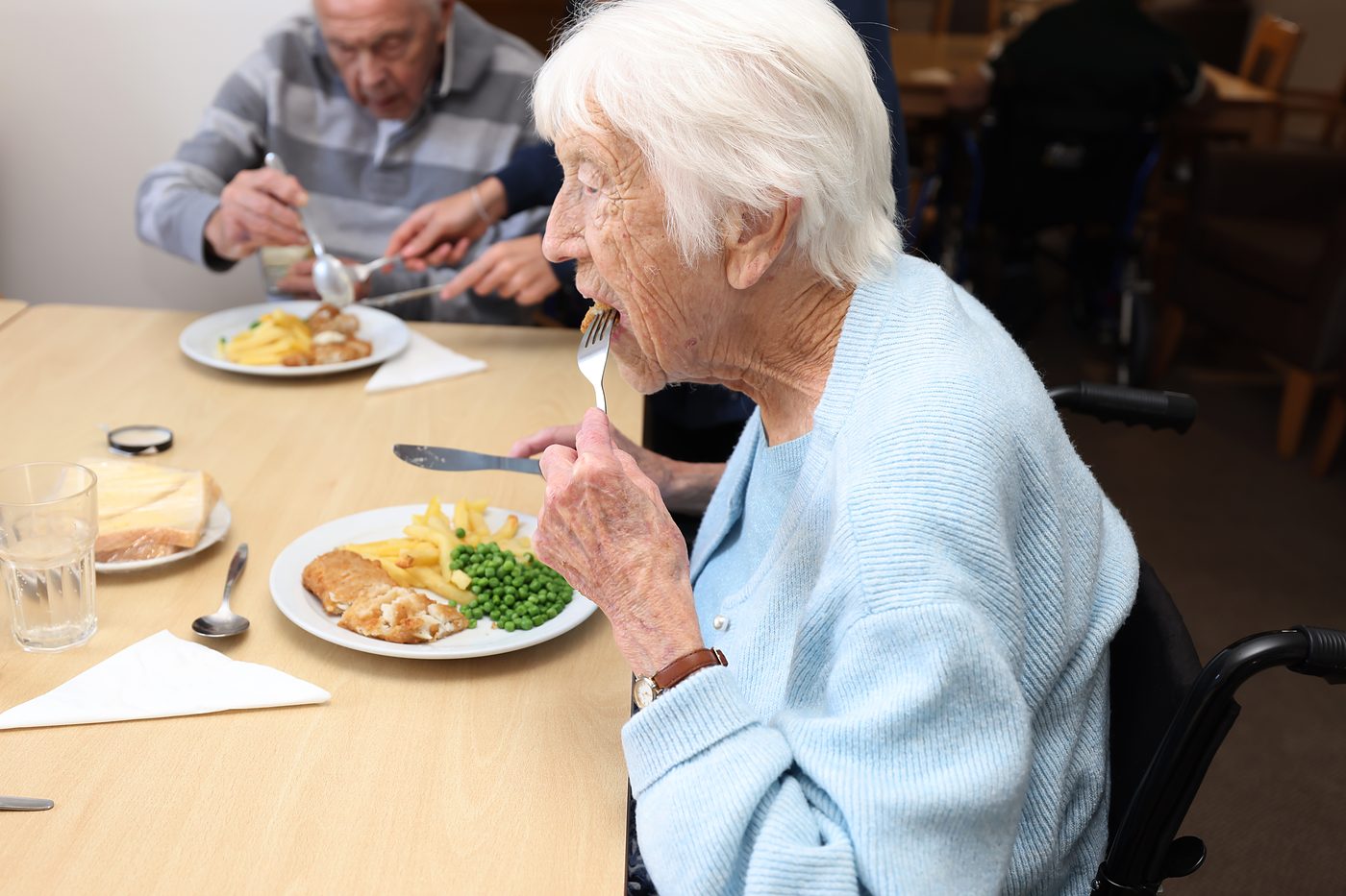 Residents enjoying a cooked lunch together in the dining room